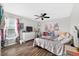 Bright bedroom featuring hardwood floors, stylish decor, and a comfortable bed at 1224 Blackwater Pond Dr, Orlando, FL 32828