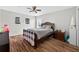 Comfortable bedroom featuring a ceiling fan, wood-look flooring, and a cozy decor at 1224 Blackwater Pond Dr, Orlando, FL 32828