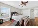 A bright bedroom featuring wood-look floors, a ceiling fan, and access to a closet at 1224 Blackwater Pond Dr, Orlando, FL 32828