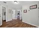 Well-lit hallway with hardwood floors and access to multiple rooms at 1224 Blackwater Pond Dr, Orlando, FL 32828