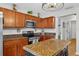 Updated kitchen featuring stainless steel appliances, an island with granite counters, and wood cabinets at 1224 Blackwater Pond Dr, Orlando, FL 32828