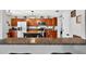 Stylish kitchen featuring wooden cabinets, granite counters, and stainless steel appliances at 1224 Blackwater Pond Dr, Orlando, FL 32828