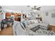 Open-concept living space with a sectional sofa, tile flooring, and views of the kitchen and dining area at 1224 Blackwater Pond Dr, Orlando, FL 32828