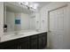 Bathroom featuring double sink vanity, framed mirror, and modern lighting at 1292 Cavender Creek Rd, Minneola, FL 34715