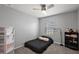 This bedroom features a ceiling fan, window, shelving, and a black bed at 1292 Cavender Creek Rd, Minneola, FL 34715