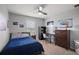 This bedroom features a ceiling fan, car art, a desk, and sports memorabilia at 1292 Cavender Creek Rd, Minneola, FL 34715
