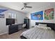 This bedroom features a ceiling fan, a desk, shelving, and an Orlando Magic flag at 1292 Cavender Creek Rd, Minneola, FL 34715