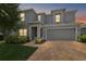 Charming two-story home featuring a spacious driveway during a lovely dusk at 1292 Cavender Creek Rd, Minneola, FL 34715