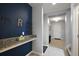 Hallway featuring a granite countertop, decorative wall art, and access to other rooms at 1292 Cavender Creek Rd, Minneola, FL 34715