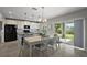 Well-lit kitchen with granite countertops, stainless appliances, and an adjacent dining area leading to the outdoors at 1292 Cavender Creek Rd, Minneola, FL 34715