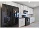 Charming kitchen showcases modern black appliances and pristine white cabinetry for a sleek and stylish design at 1292 Cavender Creek Rd, Minneola, FL 34715