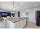 Modern kitchen with a spacious island, granite countertops, stainless steel appliances, and adjoining dining area at 1292 Cavender Creek Rd, Minneola, FL 34715