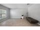 Open living room with tiled floors, a large window, and modern decor offering a bright and airy space at 1292 Cavender Creek Rd, Minneola, FL 34715