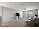 Living room with TV, ceiling fan, couch, and view of backyard at 1292 Cavender Creek Rd, Minneola, FL 34715