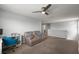Living room area with reclining couch, desk, and ceiling fan at 1292 Cavender Creek Rd, Minneola, FL 34715