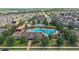 Community pool with a unique design, plenty of lounge chairs, a splash area, and a playground nearby at 1292 Cavender Creek Rd, Minneola, FL 34715