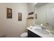 Cozy powder room with a stylish vanity, decorative mirror, and soft lighting creating a warm ambiance at 1292 Cavender Creek Rd, Minneola, FL 34715