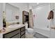 Cozy bathroom with a sink, vanity, toilet, shower and tub at 145 Piave St, Haines City, FL 33844