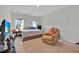 Spacious bedroom with a chair and dresser with large windows at 145 Piave St, Haines City, FL 33844