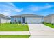 Charming single-story home with a well-maintained lawn and a two-car garage at 145 Piave St, Haines City, FL 33844