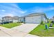 Well-maintained home with landscaped front yard and a two-car garage on a sunny day at 145 Piave St, Haines City, FL 33844