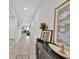 Inviting hallway with tiled flooring, decorative console table, and art displays at 145 Piave St, Haines City, FL 33844