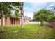 Expansive backyard with covered patio and mature landscaping at 1456 Sun Meadow Dr, Orlando, FL 32824