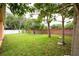 Lush backyard with verdant lawn and perimeter brick wall at 1456 Sun Meadow Dr, Orlando, FL 32824