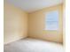 Empty bedroom with carpet flooring, a window and neutral yellow paint at 1456 Sun Meadow Dr, Orlando, FL 32824