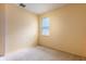 Empty bedroom with carpet flooring, a window and neutral yellow paint at 1456 Sun Meadow Dr, Orlando, FL 32824