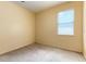 Empty bedroom with carpet flooring, a window and neutral yellow paint at 1456 Sun Meadow Dr, Orlando, FL 32824