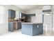 Open kitchen with tiled floors, generous cabinet space, an island, and clear view to the front entryway at 1456 Sun Meadow Dr, Orlando, FL 32824