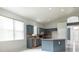 Bright open kitchen with tiled floors, cabinet storage, a central island, and plentiful natural light at 1456 Sun Meadow Dr, Orlando, FL 32824