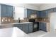 Well-appointed kitchen featuring tiled floors, ample cabinet space, and modern appliances at 1456 Sun Meadow Dr, Orlando, FL 32824