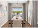 Bright dining room featuring a wooden table, neutral accents, and a sliding glass door to a balcony at 152 Royal Ranch Rd, Clermont, FL 34715