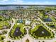 An aerial view showing a community with a pool, tennis court, playground, lakes, and sidewalks at 15900 Citrus Knoll Dr, Winter Garden, FL 34787