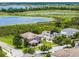 A beautiful home and lawn is nestled by a pond offering an eye-catching landscape at 15900 Citrus Knoll Dr, Winter Garden, FL 34787
