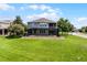 Spacious backyard featuring a screened-in patio, lush green lawn, and mature landscaping at 15900 Citrus Knoll Dr, Winter Garden, FL 34787