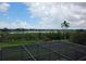 Scenic view from the screened-in patio overlooking a serene lake and natural green landscape at 15900 Citrus Knoll Dr, Winter Garden, FL 34787
