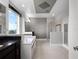Bathroom with a large tub, glass shower, and natural light from the window at 15900 Citrus Knoll Dr, Winter Garden, FL 34787