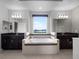 Bright bathroom features a large soaking tub set below a window with dual sink vanities at 15900 Citrus Knoll Dr, Winter Garden, FL 34787