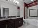 Bathroom with double sink vanity, shower and tub combo with tile surround at 15900 Citrus Knoll Dr, Winter Garden, FL 34787
