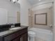 Bathroom featuring tiled shower-tub and a dark wood vanity at 15900 Citrus Knoll Dr, Winter Garden, FL 34787