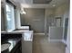Elegant bathroom featuring a soaking tub, walk-in shower, dual sinks, and granite countertops for a spa experience at 15900 Citrus Knoll Dr, Winter Garden, FL 34787