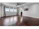 Large bedroom with hardwood floors, three windows, and a ceiling fan at 15900 Citrus Knoll Dr, Winter Garden, FL 34787