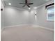 Bedroom with neutral carpet, ceiling fan and fixtures, and bright light from the window at 15900 Citrus Knoll Dr, Winter Garden, FL 34787
