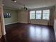 Spacious bedroom with hardwood floors, a ceiling fan, large windows, and neutral paint, perfect for relaxation at 15900 Citrus Knoll Dr, Winter Garden, FL 34787