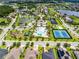 Aerial of a Primary-planned community featuring a pool, tennis courts, a playground, and scenic lakes at 15900 Citrus Knoll Dr, Winter Garden, FL 34787
