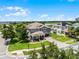 Beautiful two-story gray home with a well-manicured lawn and a brick driveway in a waterfront community at 15900 Citrus Knoll Dr, Winter Garden, FL 34787