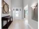 Bright foyer with high ceilings, decorative lighting and console table, creating a welcoming entrance at 15900 Citrus Knoll Dr, Winter Garden, FL 34787